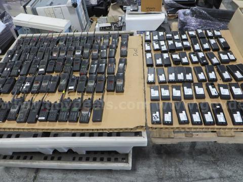 73 Hand-held radios, 69 batteries, and a case of clips.